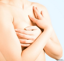 Woman's chest, hands gently touching