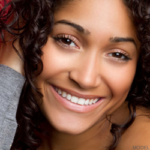 Woman with curly dark hair smiling