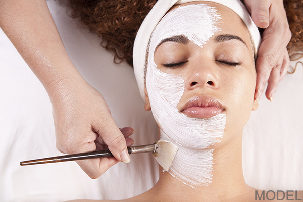 Woman receiving a facial mask application